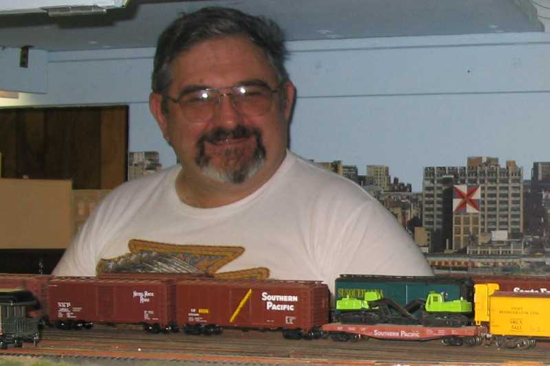 Charlie Richmond stops his job as yard master on Don Bozman's Great Great Northern layout long enough to pose for this photo. Do you think he is having fun?